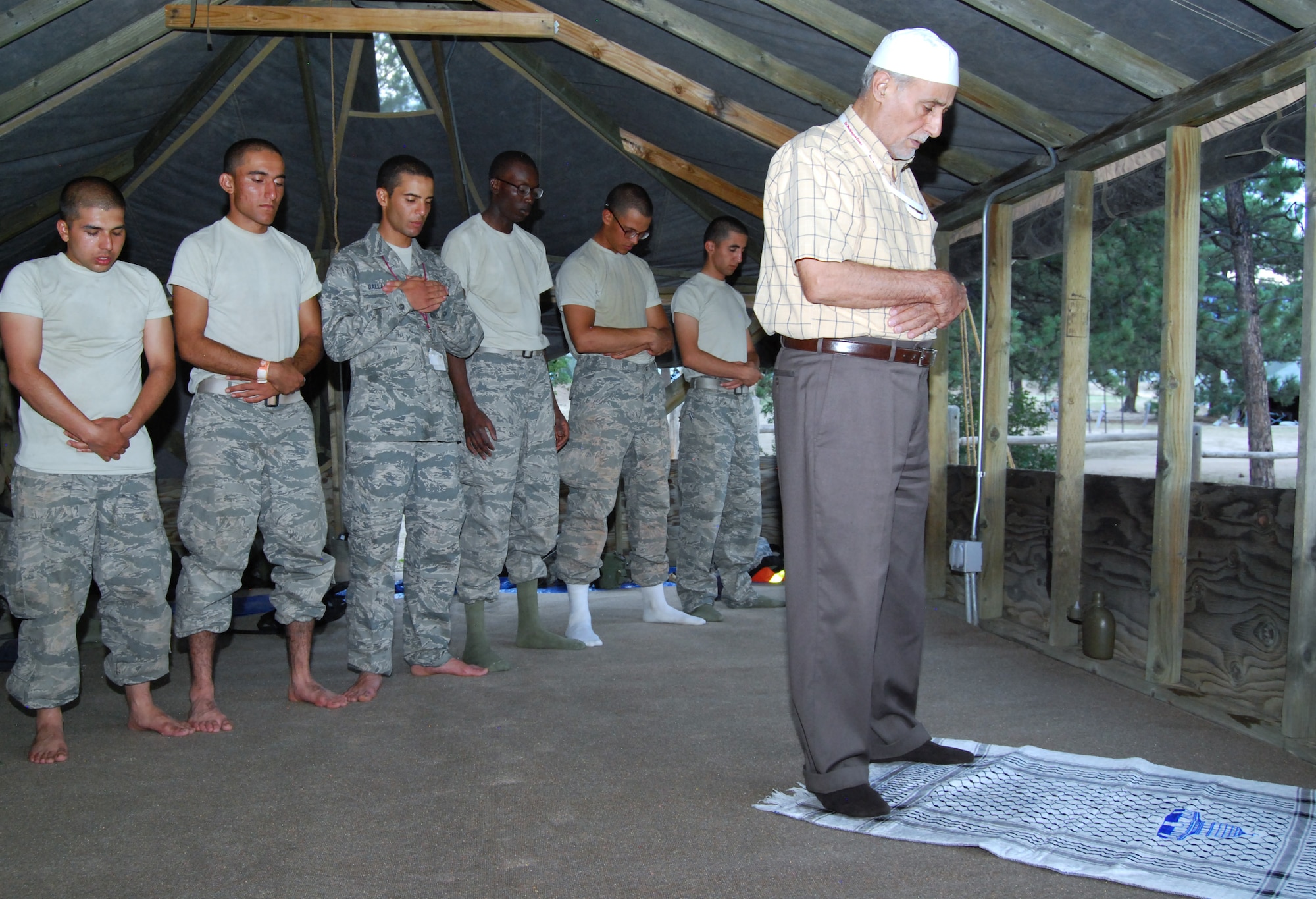 Imam Mohamed Jodeh leads basic cadets in evening prayer during a Muslim service in Jacks Valley July 22, 2012. While Muslims normally fast during Ramadan, which began July 20, Jodeh instructed the basics not to fast while they underwent Basic Cadet Training. (U.S. Air Force photo/Don Branum)