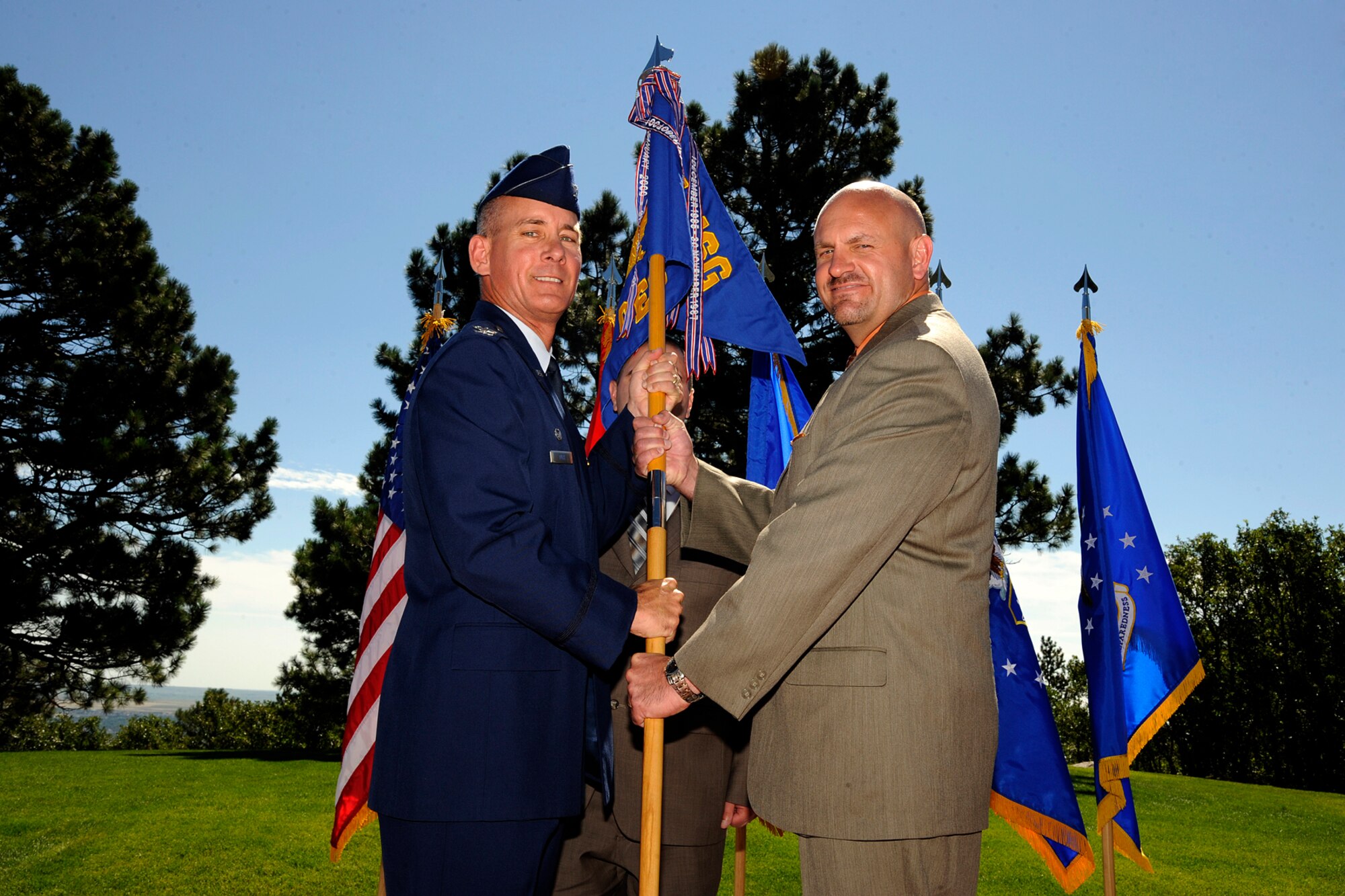 Col. Joseph Turk, 721st Mission Support Group commander, appoints leadership of the newly activated 721st Civil Engineer Squadron to Dino Bonaldo II in a ceremony July 17, 2012 at Cheyenne Mountain Air Force Station. Bonaldo’s appointment as the civilian squadron commander equivalent is a unique feature in the 21st Space Wing, as the 721st CES is 100 percent civilian manned. (U.S. Air Force photo/Rob Bussard)