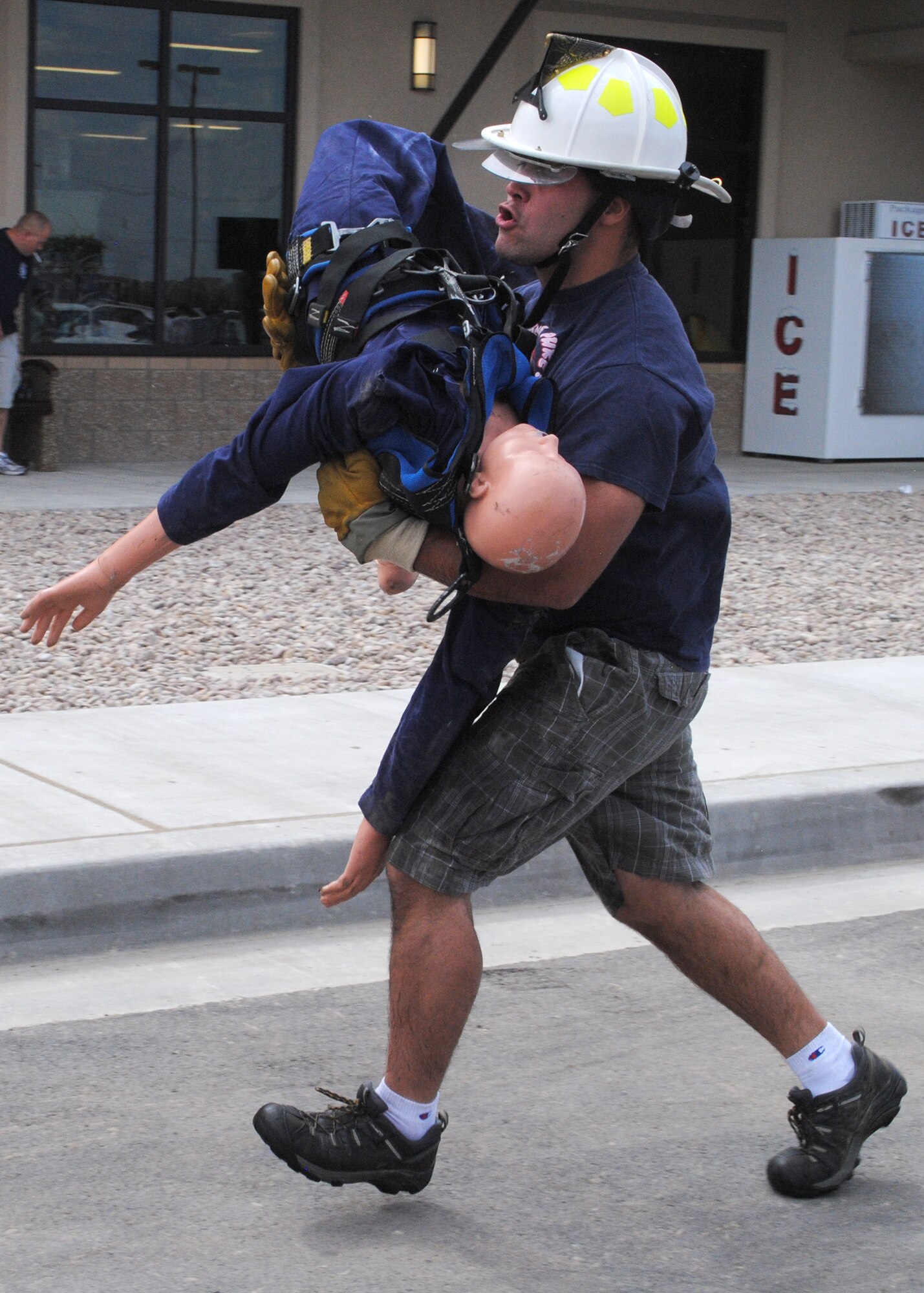 Staff Sgt. Ryan Ruffini, 12th Missile Squadron facility manager, carries a 120lb dummy more than 75 feet to tag one of his teammates.  This station was one of seven fire department-inspired tasks participants had to accomplish in the Fire Muster Competition July 20.  (U.S. Air Force photo/Airman 1st Class Cortney Paxton)