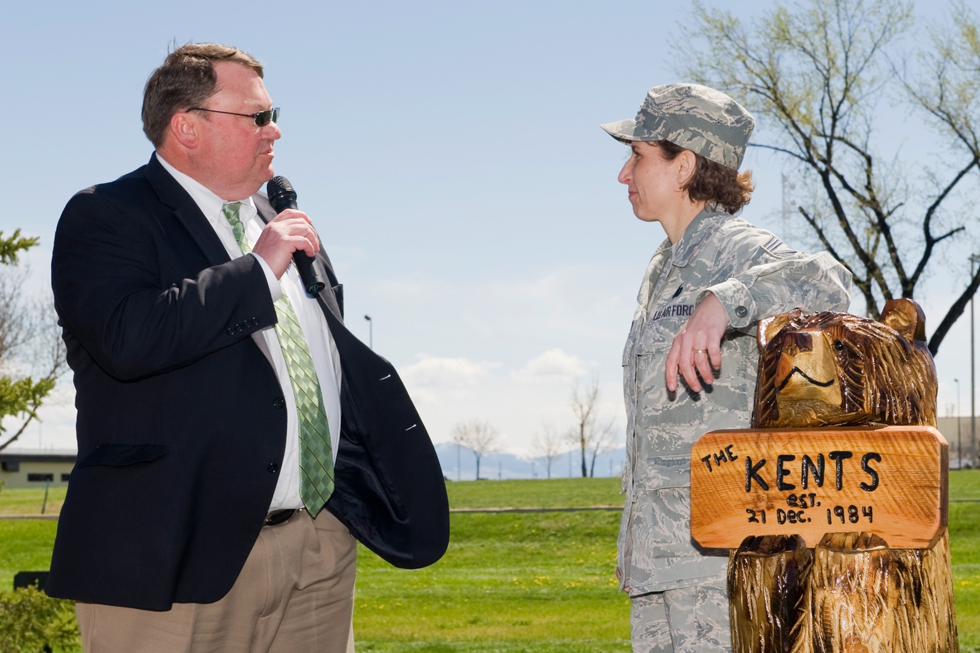 Steve Grooms, president and CEO of 1st Liberty Federal Credit Union, addresses then-Command Chief Master Sgt. Cari Kent at her going away party. Kent is leaning on a wood carving that was presented to her by the first sergeants and Top 3 members as a farewell gift. (U.S. Air Force photo/Beau Wade)