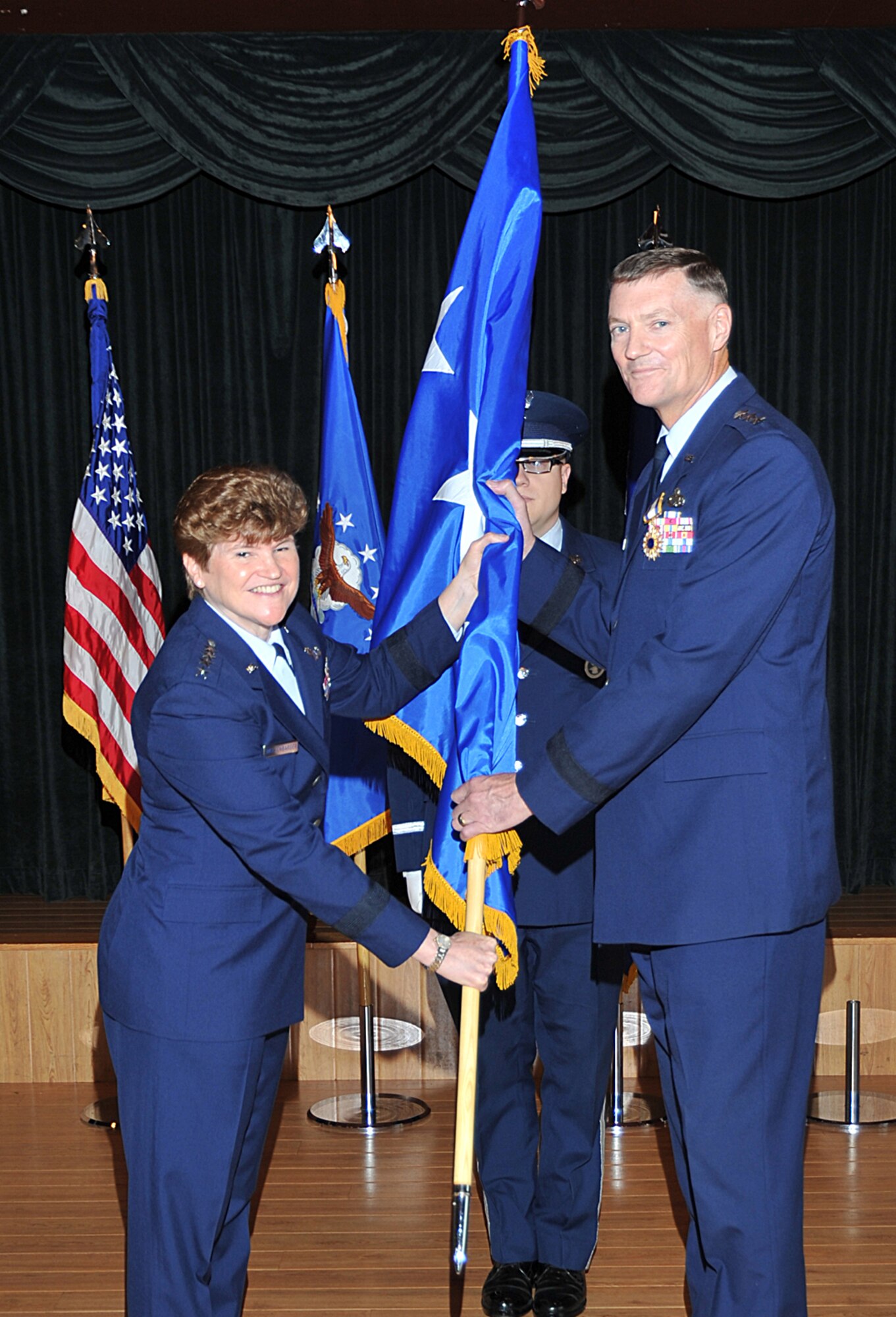 Gen. Janet Wolfenbarger, Air Force Materiel Command commander, passes the
three-star flag to Lt. Gen. Andrew Busch, AFMC vice commander, during
Busch's promotion ceremony July 26 at the Wright-Patt Club and Banquet
Center. (U.S. Air Force photo/Ben Strasser)

