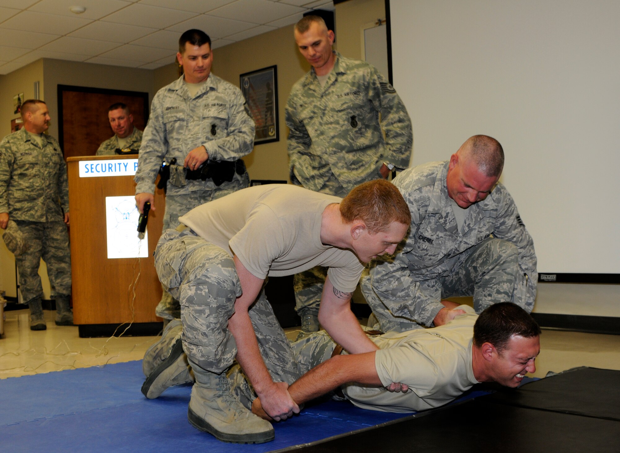 The 188th Security Forces Squadron conducted an initial training class July 14 to certify its Airmen on the TASER stun gun. Twenty-five SFS Airmen certified on the weapon during the class, which spanned six hours and included a written examination, a functional test under duress and the discharge of two cartridges from the X26 TASER. (National Guard photo by Airman 1st Class Hannah Landeros/188th Fighter Wing Public Affairs)