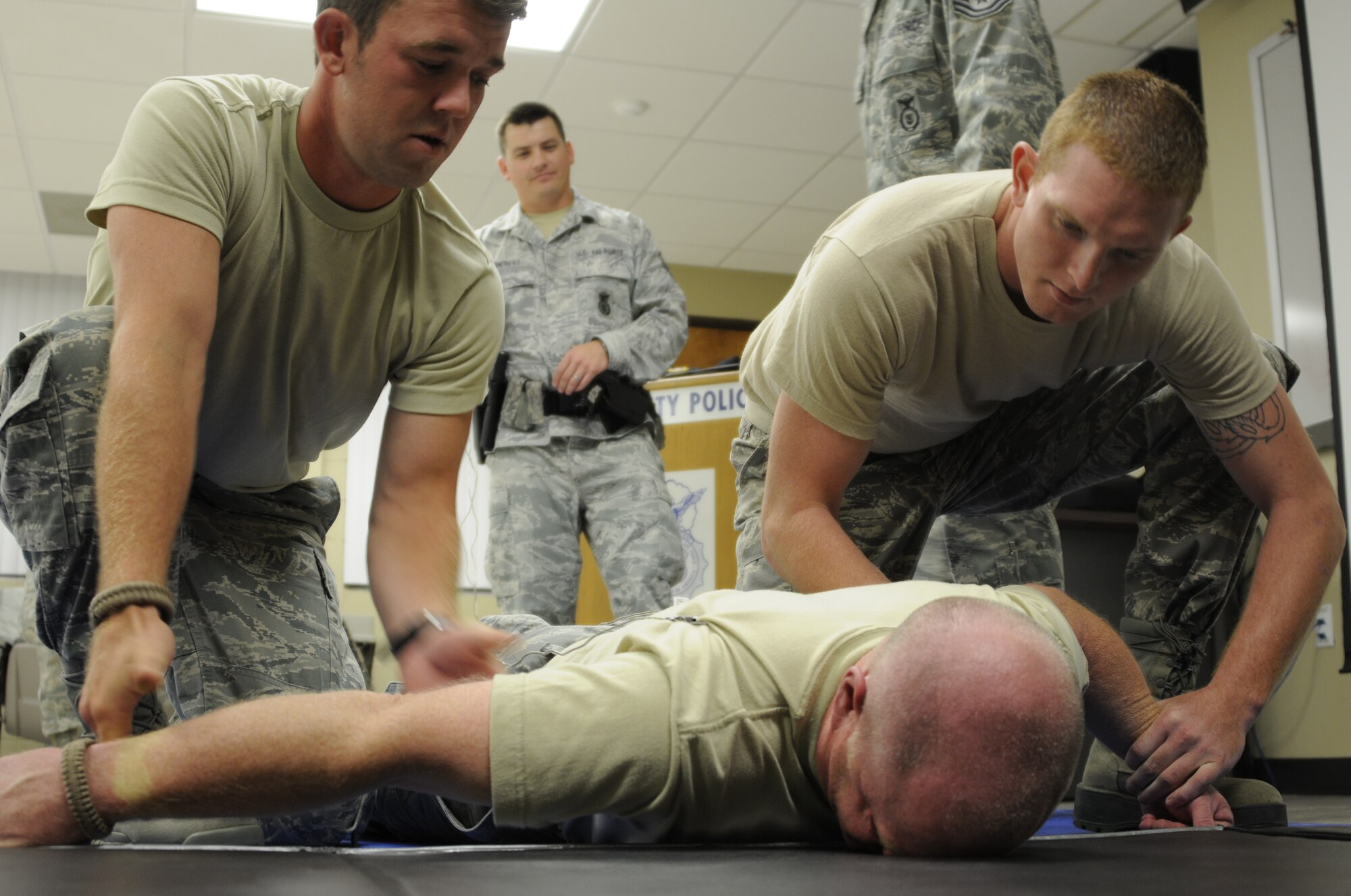 The 188th Security Forces Squadron conducted an initial training class July 14 to certify its Airmen on the TASER stun gun. Twenty-five SFS Airmen certified on the weapon during the class, which spanned six hours and included a written examination, a functional test under duress and the discharge of two cartridges from the X26 TASER. (National Guard photo by Airman 1st Class Hannah Landeros/188th Fighter Wing Public Affairs)