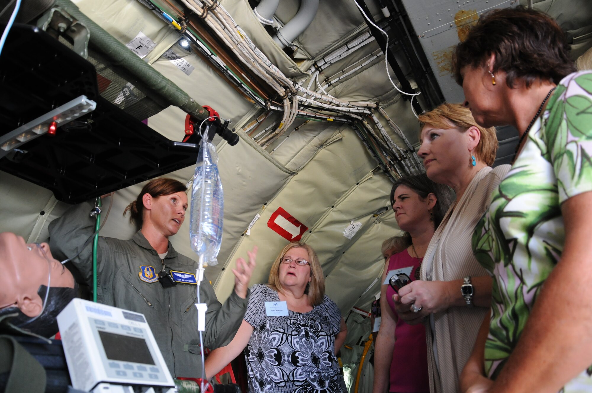 JOINT BASE ANDREWS, Md.,- Air Force Tech. Sgt. Beth Young from the 459th Aeromedical Evacuation Squadron here, briefs a group of military spouses on the process of an aeromedical evacuation during a Senior Leader’s Orientation Course, July 26, 2012. The SLOC is an annual event designed for newly promoted one-star generals, their spouses and senior executive leaders. The course is broken up into two sections; one for the generals, and one for the spouses. During the five-day spouse course, the 85 participants from around the U.S. Air Force toured different aircraft, visited the 779th  Aeromedical Staging Facility, met with a wounded warrior panel, and learned about different resources to bring back to their respective installations. (U.S. Air Force photo/Senior Airman Katie Spencer)