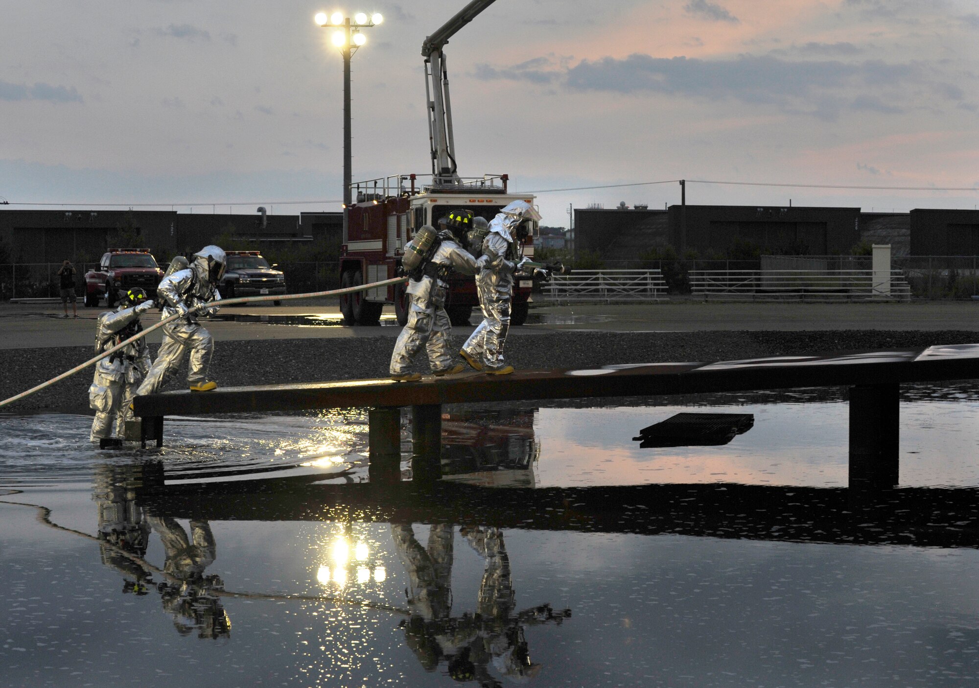 U.S. Air Force firefighters with the 35th Civil Engineer Squadron instruct incident commanders on how to approach a fire during a live fire demonstration at Misawa Air Base, Japan, July 26, 2012. Incident commanders normally coordinate and direct operations during an emergency, but the demonstration put them at the frontlines as they learned how to fight a fire. (U.S. Air Force photo by Staff Sgt. Nathan Lipscomb/Released)