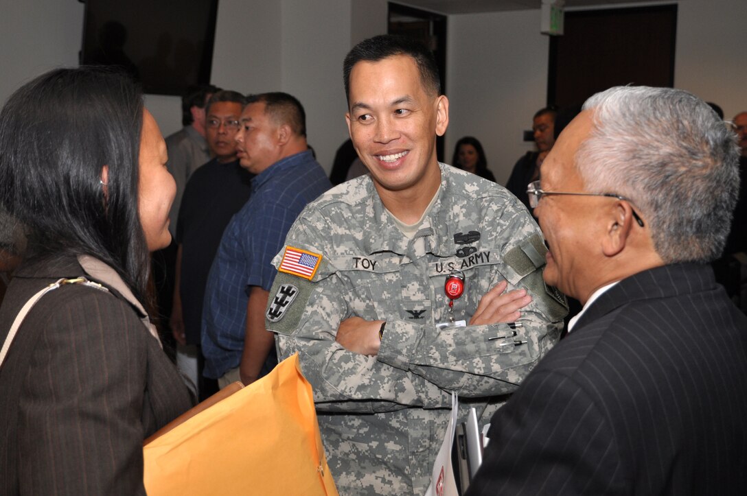 Col. Mark Toy, District commander speaks with two of the more than 200 business owners that met division chiefs and project managers from the U.S. Army Corps of Engineers Los Angeles District to learn about contract opportunities and, in some cases, simply to learn how to get started in doing business with the Corps during an open house July 25.