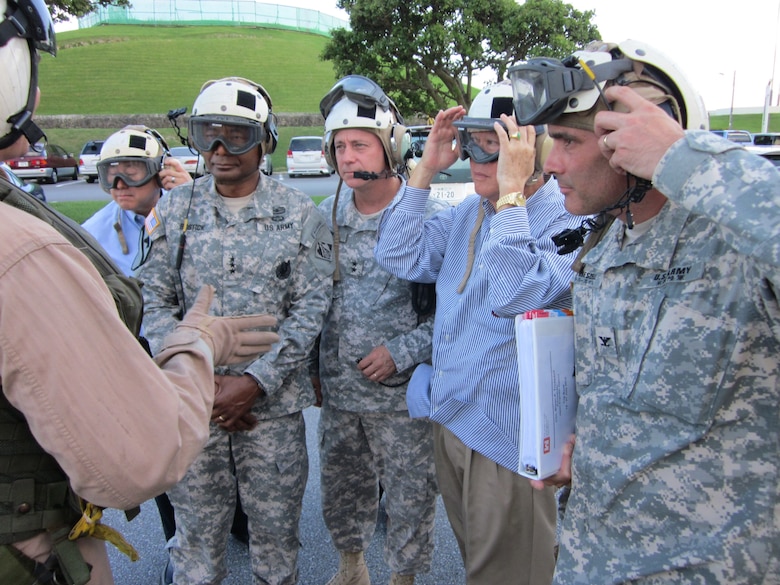 OKINAWA, Japan — Lt. Gen. Thomas Bostick, commanding general of the U.S. Army Corps of Engineers (USACE), Maj. Gen. Kendall P. Cox, USACE deputy commanding general, military and international operations, Gene Ban, USACE director of programs, Pacific Ocean Division, & Col. Bryan P. Truesdell, USACE Japan District commander, receive pre-flight instructions during a visit to the Okinawa Area Office July 18, 2012.