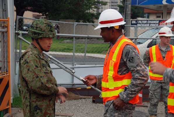 CAMP ZAMA, Japan — Lt. Gen. Thomas P. Bostick, commanding general of the U.S. Army Corps of Engineers, exchanges command coins with Col. Takeshi Ishimaru, commander, 4th Engineer Group, Japan Ground Self Defense Force, following a briefing here, July 20, 2012.