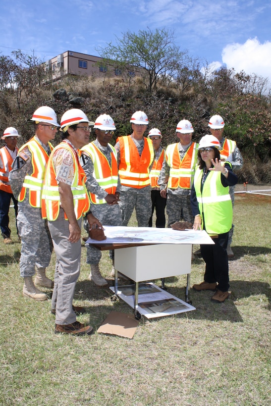 Commanding General U.S. Army Corps of Engineers Lt. Gen. Thomas P. Bostick (front row; third from left) listens as Command and Control Facility (C2F) Program Manager/ Project Manager Lise Ditzel-Ma explains the project site layout of the future headquarters for U.S. Army Pacific during a visit July 23.; Listening are (front row left to right) Maj. Gen. Kendall P. Cox; deputy commanding general USACE; C2F Phase One Project Engineer Gerald Young; Lt. Gen. Bostick; Honolulu District Commander Lt. Col. Thomas D. Asbery; Honolulu District Fort Shafter Area Office Engineer Tim Phillips; Col. Robert Sinkler; Strategic Planner USACE; Ditzel-Ma and Col. Peter Andrysiak; Executive Officer; USACE. 