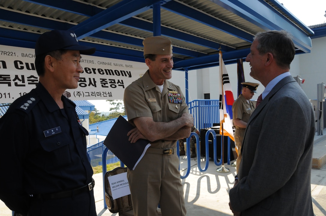 Rear Adm. William McQuilkin (center), Commander U.S. Naval Forces Korea, discusses the new Bachelor Enlisted Quarters at Fleet Activities Chinhae with Sam Adkins (right), Chief of the U.S. Army Corps of Engineers, Far East District Construction Division. Col. Han Bong-wan, Chief of U.S. Forces Korea Construction Management Team, Korea Ministry of National Defense looks on. (Photo by Patrick Bray)