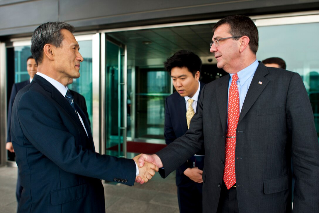 U.S. Deputy Defense Secretary Ashton B. Carter bids farewell to South Korean Defense Minister Kim Kwan-jin in Seoul, South Korea, July 26, 2012.