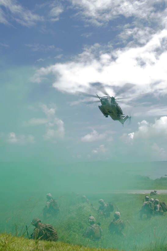 KIN BLUE, Okinawa, Japan – A CH-53E Super Stallion helicopter from Marine Medium Helicopter Squadron 262 (Reinforced) lands through green signal smoke to recover Marines from the Tactical Recovery of Aircraft and Personnel team of the 31st Marine Expeditionary here, July 26. The 31st MEU is the Marine Corps' force in readiness for the Asia-Pacific region.