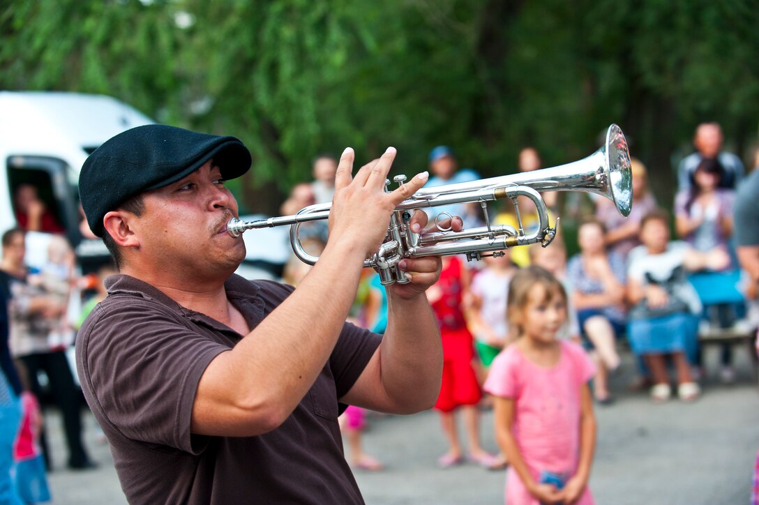 Airman 1st Class Allen Valladares plays his trumpet during a U.S. Air Forces Central Band "Vector" performance at the Maevka House of Culture in Maevka Village, Kyrgyzstan, July 27, 2012. Vector performed for audiences across Kyrgyzstan as part of a nine-day tour. Valladares is deployed out of the Channel Islands Air National Guard Station, Calif. and a native of Los Angeles. (U.S. Air Force photo/Senior Airman Brett Clashman)