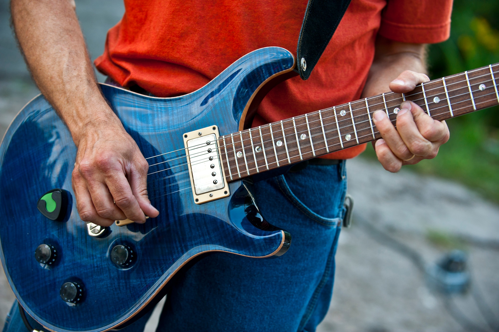 Tech. Sgt. Daniel Plaster jams on his guitar during a U.S. Air Forces Central Band "Vector" performance at the Maevka House of Culture in Maevka Village, Kyrgyzstan, July 27, 2012. The U.S. and Kyrgyz Republic continue to develop friendships and cooperation after 20 years. Plaster is deployed out of the Channel Islands Air National Guard Station, Calif. He is a native of Redundo Beach, Calif. (U.S. Air Force photo/Senior Airman Brett Clashman)
