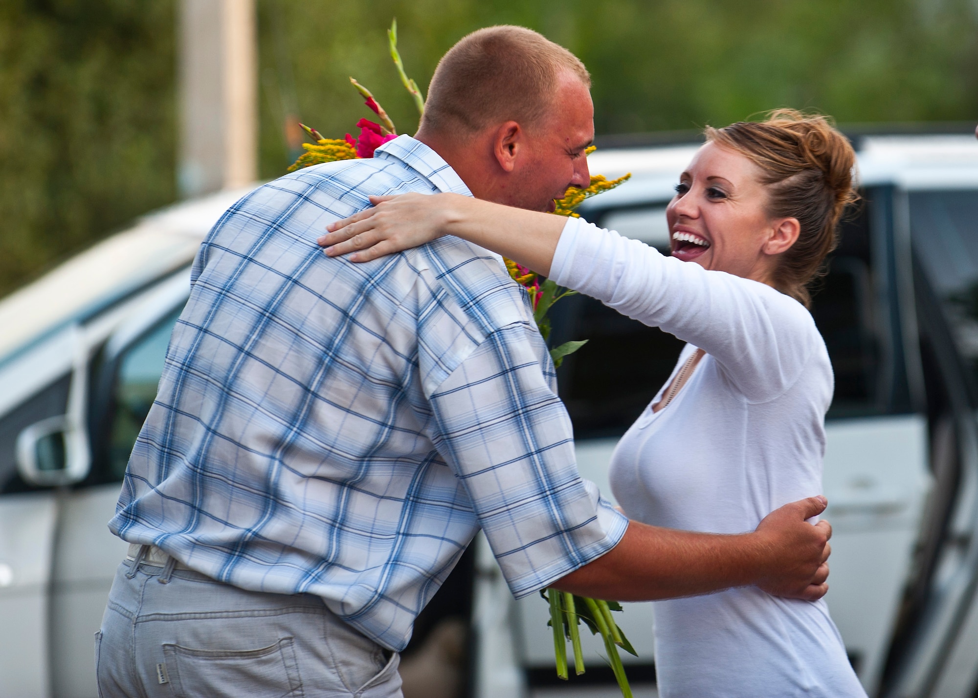 Staff Sgt. Samantha Renner receives flowers from Roman Plovhitii during a U.S. Air Forces Central Band "Vector" performance at the Maevka House of Culture in Maevka Village, Kyrgyzstan, July 27, 2012. Renner, along with Vector band members, were given flowers as a appreciative gesture. Renner is a 376th Expeditionary Logistics Readiness Squadron resource controller at the Transit Center at Manas, Kyrgyzstan and is deployed out of Luke Air Force Base, Ariz. She is a native of Fremont, Neb.(U.S. Air Force photo/Senior Airman Brett Clashman)