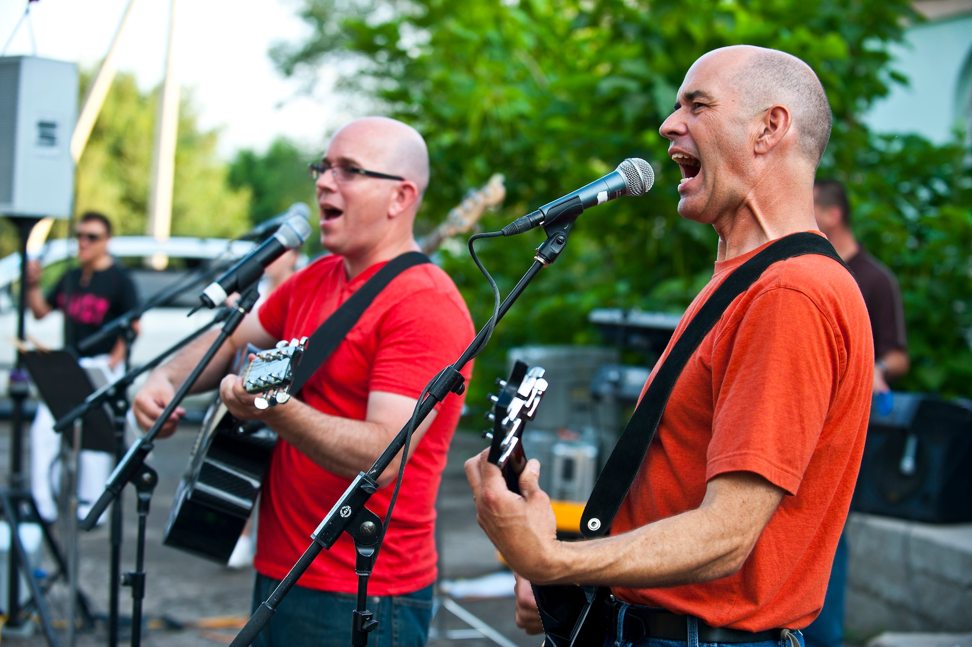 Tech. Sgt. Daniel Plaster (right) and Tech. Sgt. Brian Hollett sing together during a U.S. Air Forces Central Band "Vector" performance at the Maevka House of Culture in Maevka Village, Kyrgyzstan, July 27, 2012. Vector performed a mix of genres to include salsa, country and classic rock. (U.S. Air Force photo/Senior Airman Brett Clashman)