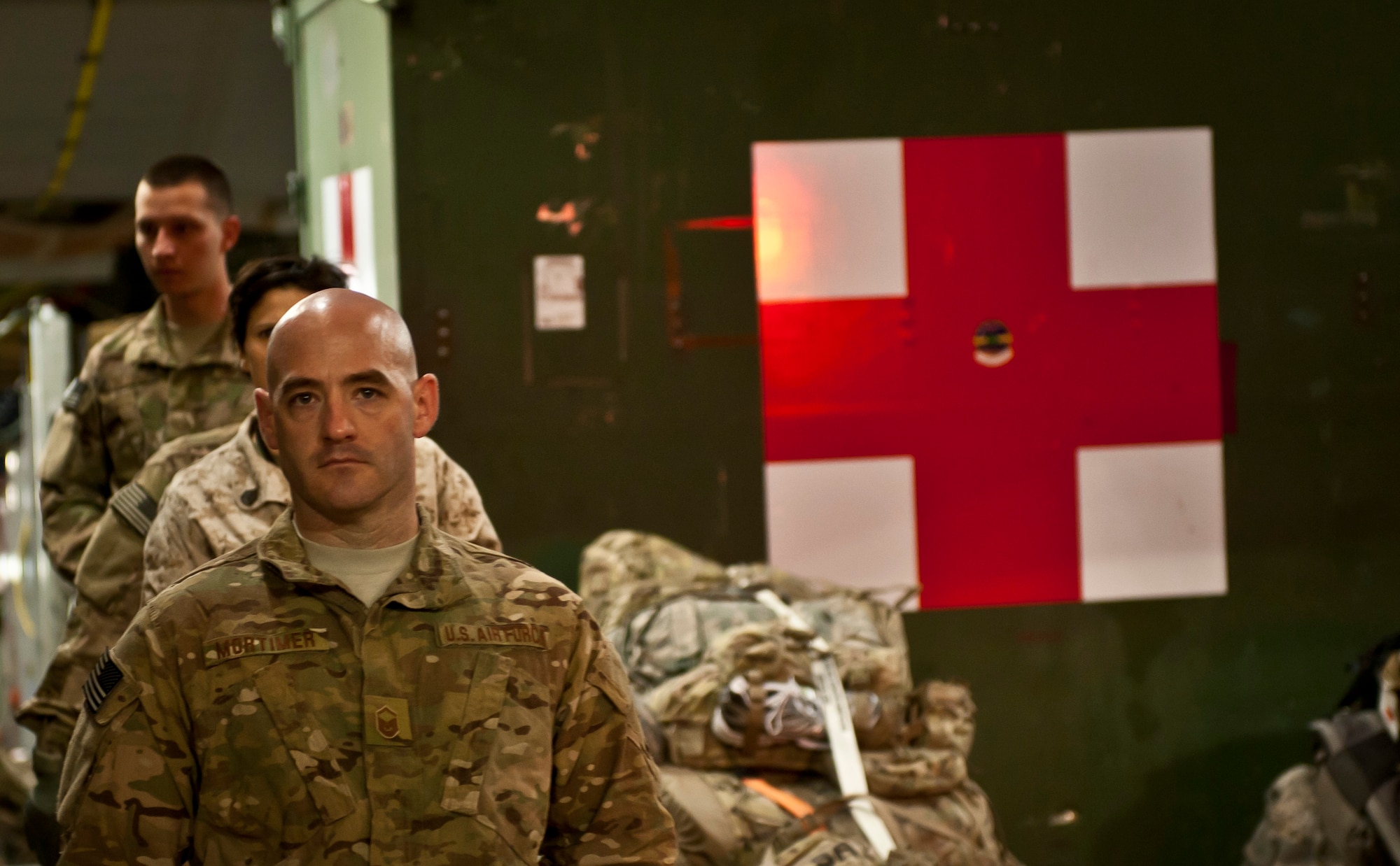 MSgt Shane Mortimer, a radio operator with the 455th Expeditionary Aeromedical Evacuation Squadron, steps off a C-17 Globemaster III at Bagram Airfield, Afghanistan, July 23, 2012. Mortimer regularly supports the Contingency Aeromedical Staging Facility team as they move wounded warriors from the battlefield. (U.S. Air Force Photo/Capt. Raymond Geoffroy)