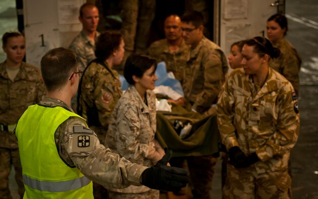 Contingency Aeromedical Staging Facility personnel and volunteers move a patient to an awaiting C-17 Globemaster III at Bagram Airfield, Afghanistan, July 23, 2012. Bagram’s CASF staff relies on a dedicated team of volunteers to safely transport wounded warriors off the battlefield. (U.S. Air Force Photo/Capt. Raymond Geoffroy)