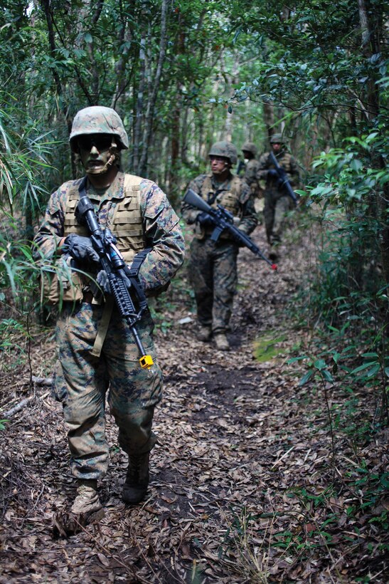 Lance Cpl. Stephen M. Henderson patrols ahead of his squad during an exercise at Camp Gonsalves May 22. Henderson is a special intelligence communicator with 3rd Radio Battalion, III Marine Expeditionary Force Headquarters Group, III MEF, and currently assigned to the 31st Marine Expeditionary Unit.
