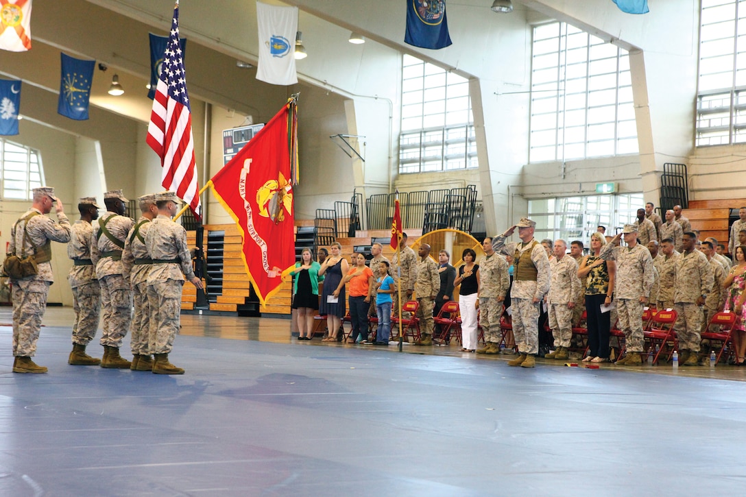 Marines, sailors and family members salute the colors during a ceremony at the field house at Camp Foster June 4. Marine Wing Support Group 17 deactivated during the ceremony per Marine Corps Bulletin 5400 that deactivates all MWSGs throughout the Marine Corps. MWSG-17 was formerly part of 1st Marine Aircraft Wing, III Marine Expeditionary Force. 
