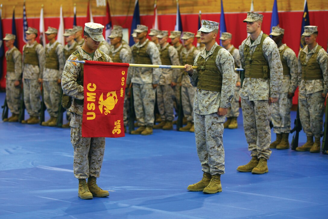 1st Lt. Cliff S. Cardwell unveils the guidon for Company C at the activation ceremony for 3rd Law Enforcement Battalion at Camp Hansen June 7. The battalion, part of the III Marine Expeditionary Force Headquarters Group, III MEF, activated to improve law enforcement capabilities under III MEF. Cardwell is the commanding officer of Company C. The battalion's commanding officer is Lt. Col. Amy R. Ebitz.
