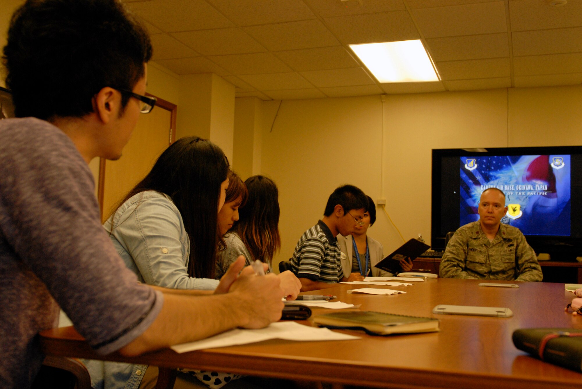 U.S Air Force Maj. Christopher Anderson, 18th Wing Public Affairs chief, answers questions from the Ryukyu University students during an 18th Wing mission briefing on Kadena Air Base, July 26, 2012. The university students came to Kadena to educate themselves on the international defense in this region. (U.S. Air Force photo/ Airman 1st Class Malia Jenkins)   