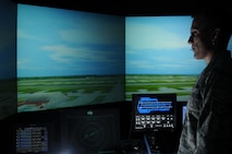 ANDERSEN AIR FORCE BASE, Guam – Tech. Sgt. Chad Thompson, 36th Operations Support Squadron tower watch supervisor, watches over a virtual layout of Andersen Air Force Base’s flightline July 20. The virtual layout is within a virtual air traffic control tower simulation that allows controllers to hone in on the skills required to control a busy flightline. (U.S. Air Force photo by Senior Airman Carlin Leslie/Released)