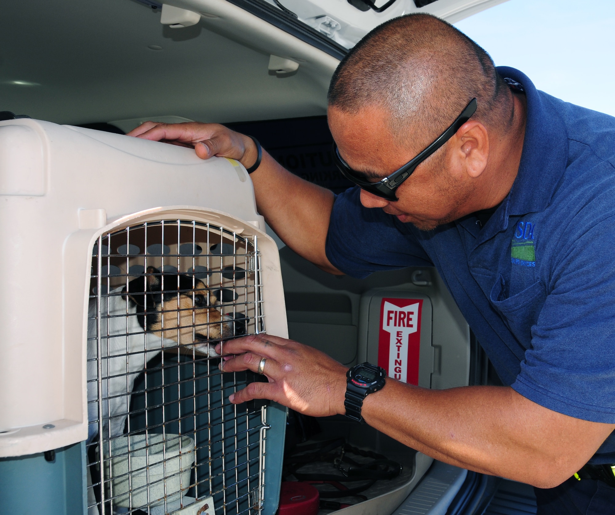 ANDERSEN AIR FORCE BASE, Guam— ANDERSEN AIR FORCE BASE, Guam—Richard Napoleon, U.S. Department of Agriculture canine handler, and his partner, Chico, inspect a KC-135 Stratotanker for brown tree snakes, July 24.  One of the goals of USDA is to keep this invasive species from spreading to other territories and islands in the Pacific. (U.S Air Force photo by Senior Airman Benjamin Wiseman/Released)