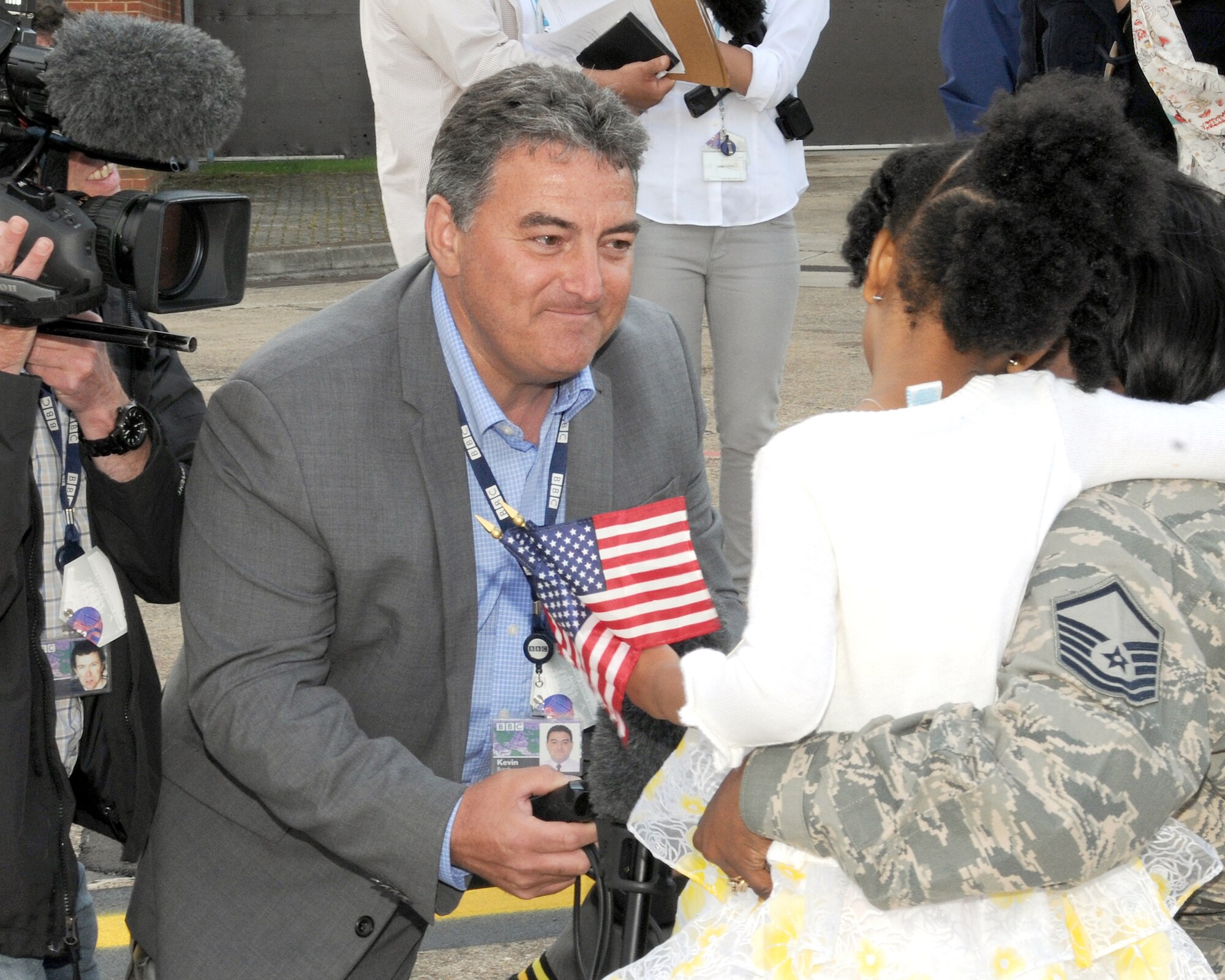 RAF MILDENHALL, England – Kevin Burch, BBC Look East reporter, interviews a military family following first lady Michelle Obama’s visit to U.S. military families at RAF Mildenhall here July 29, 2012.  Families assigned to RAF Mildenhall, RAF Lakenheath and the 501st Combat Support Wing were among the families the first lady met with prior to her departure.  Obama stopped at the base as part of the Joining Forces initiative. While in the U.K., the first lady met with approximately 1,000 British and American children as part of her Let’s Move! campaign and was also the U.S. presidential delegation for the opening ceremony of the 2012 Olympic Games. (U.S. Air Force photo/Master Sgt. Brian M. Boisvert)