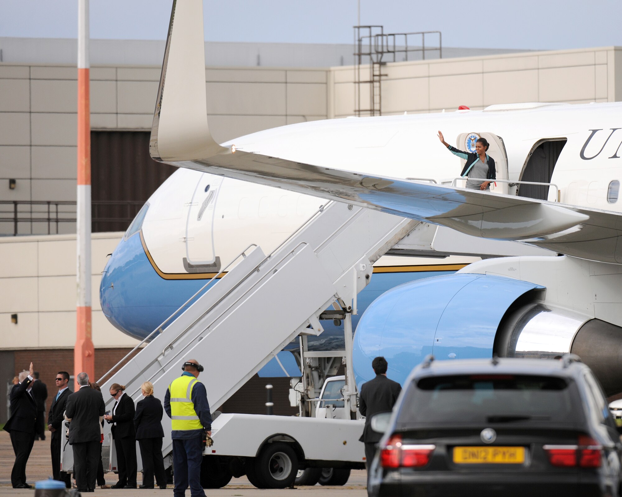 RAF MILDENHALL, England -- First lady Michelle Obama waves to U.S. military families at RAF Mildenhall here July 29, 2012. Families assigned to RAF Mildenhall, RAF Lakenheath and the 501st Combat Support Wing were among the families the first lady met with prior to her departure.  Obama stopped at the base as part of the Joining Forces initiative. While in the U.K., the first lady met with approximately 1,000 British and American children as part of her Let’s Move! campaign and was also the U.S. presidential delegation for the opening ceremony of the 2012 Olympic Games. (U.S. Air Force photo/Master Sgt. Brian M. Boisvert)