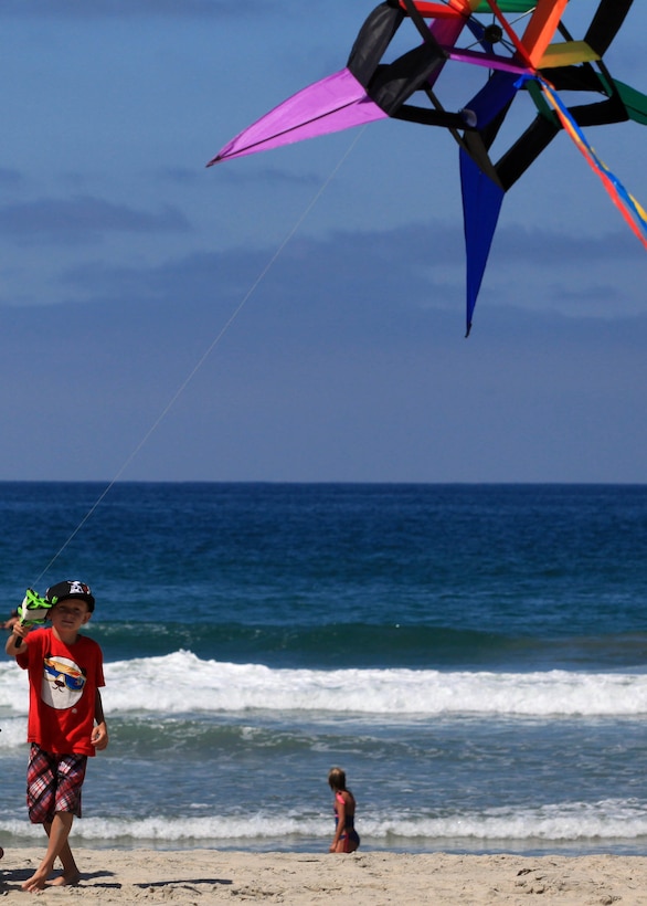 Orion Gates, 7, lets his kite fly in the wind during a kite day event on Camp Pendleton's Del Mar Beach, July 29. The event, hosted by the Del Mar Beach Resort, provided service members and their families with music, food, face painting and a kite making and flying tutorial workshop. For more information about future events on Del Mar Beach, visit www.mcccsp.com/delmarbeach.