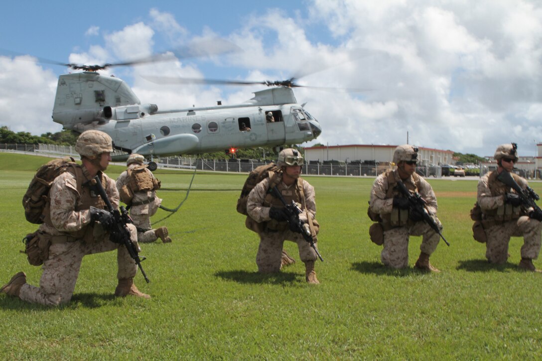 CAMP HANSEN, Okinawa, Japan – Marines with Battalion Landing Team 2nd Battalion, 1st Marine Regiment, 31st Marine Expeditionary Unit, assemble beside a CH-46E Sea Knight helicopter from Marine Medium Helicopter Squadron 262 (Reinforced), during a fast rope training evolution here, July 27. The 31st MEU is the Marine Corps’ force in readiness for the Asia Pacific region.