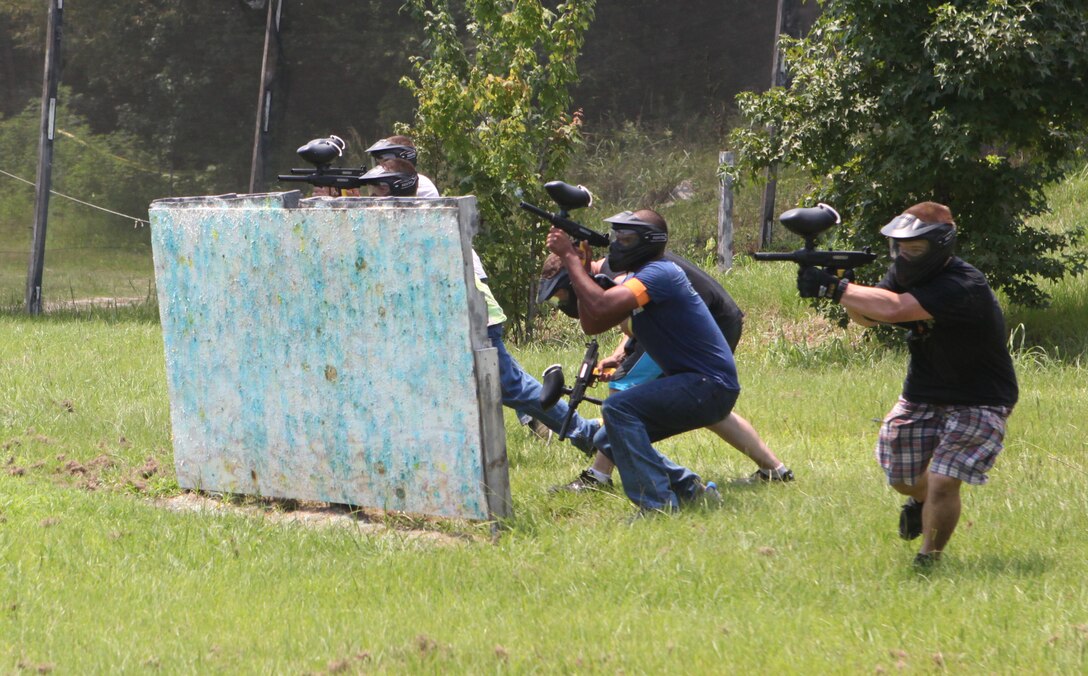 A team of Marines from Marine Corps Base Camp Lejeune quickly disperses to advance toward their opponents during a Single Marine Program paintballing trip hosted at the Sportsman’s Lodge in Jacksonville July 27. The Marines battled each other on a playing field approximately 26 acres large, offering a variety of environments such as an urban combat town, speedball and wooded course.