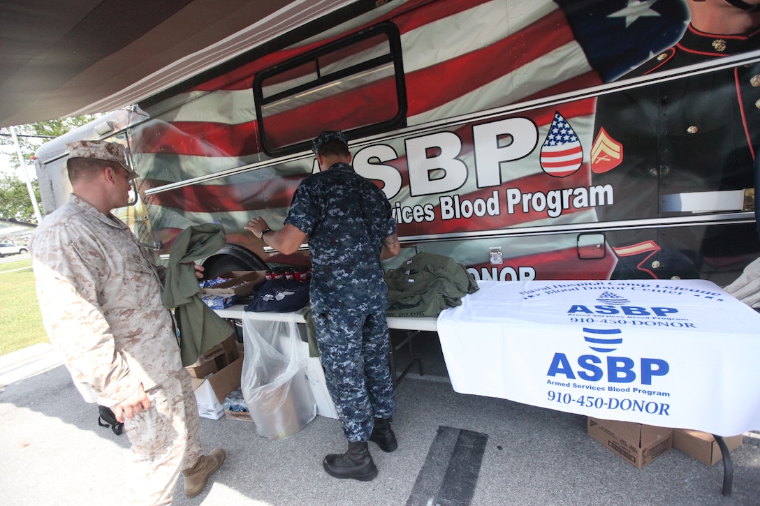 A Marine with Headquarters and Support Battalion takes a free giveaway after donating blood during the Armed Services Blood Program blood drive aboard Marine Corps Base Camp Lejeune July 27. The ASBP collects approximately 150,000 units of blood annually from the military forces. 