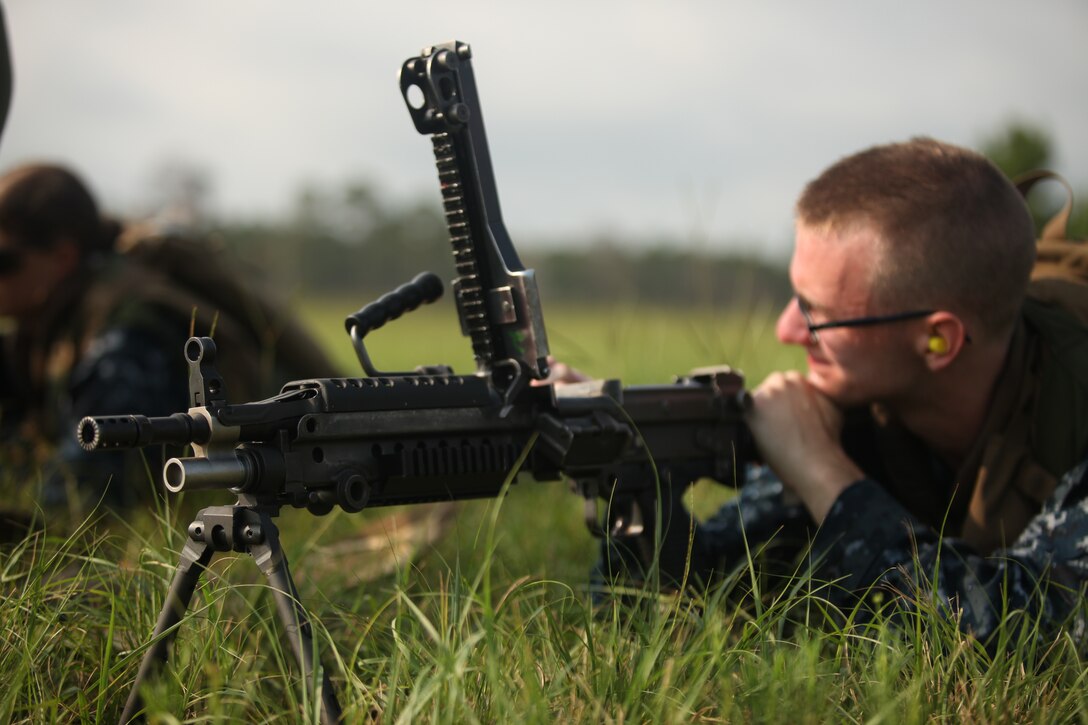 A midshipman learns how to dissemble M249 light machine gun during a day of shooting and learning about many different kinds of weaponry aboard Marine Corps Base Camp Lejeune July 26. The M249 LMG was just one of many weapon systems the midshipmen learned about from Marines who use the weapons on a daily basis.