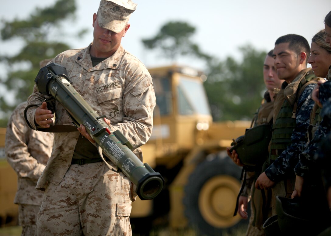 A Marine gives a group of midshipmen a class on the AT4-CS light anti-armor weapon and how it works aboard Marine Corps Base Camp Lejeune July 26 as part of Career Orientation and Training for Midshipmen. The midshipmen learned the AT-4 can only be used once and after the rocket is fired, it cannot be fired again.