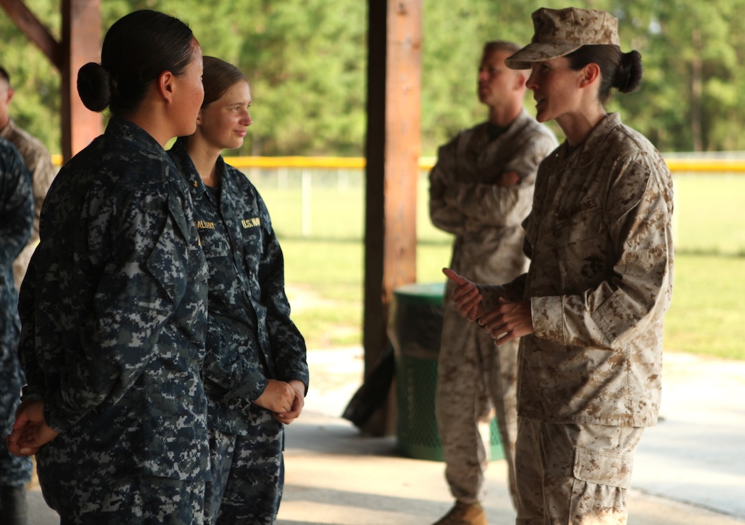 A Marine officer talks with two Midshipmen about training during a dinner and military occupational specialty mixer aboard Marine Corps Air Station New River July 26. Midshipmen were able to talk with officers of various occupations and get advice on different jobs.