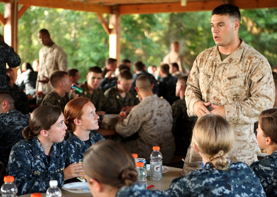 A group of midshipmen listen intently as a Marine officer discusses various aspects of the military with them during a dinner and military occupational specialty mixer aboard Marine Corps Air Station New River July 26. The midshipmen enjoyed a relaxing dinner after a long week of training aboard Marine Corps Base Camp Lejeune.