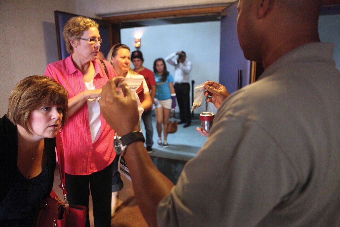 U.S. Air Force Master Sgt. Willie Jones displays various types of spice for onlookers during a spice awareness brief at the Keystone Theater at Kadena Air Base June 5. Jones is an investigator with 18th Wing Security Forces Squadron, Kadena Air Base. 
