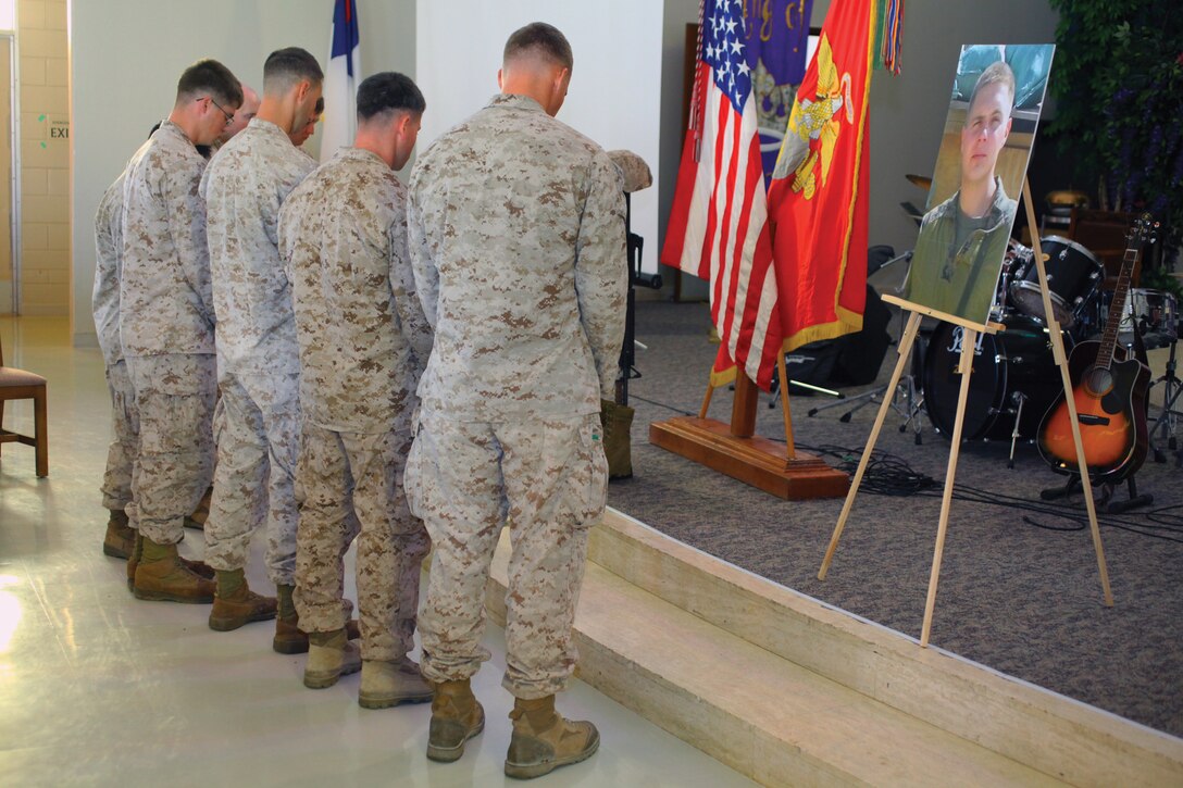 Marines with 5th Air Naval Gunfire Liaison Company observe a moment of silence for Sgt. Julian C. Chase in the chapel at Camp Hansen June 14. Chase was killed in action May 28 in Helmand province, Afghanistan. Chase's personal awards include the Purple Heart, Navy and Marine Corps Commendation Medal and Combat Action Ribbon. Chase was a fire support man with the company, part of III Marine Expeditionary Force Headquarters Group, III MEF. 
