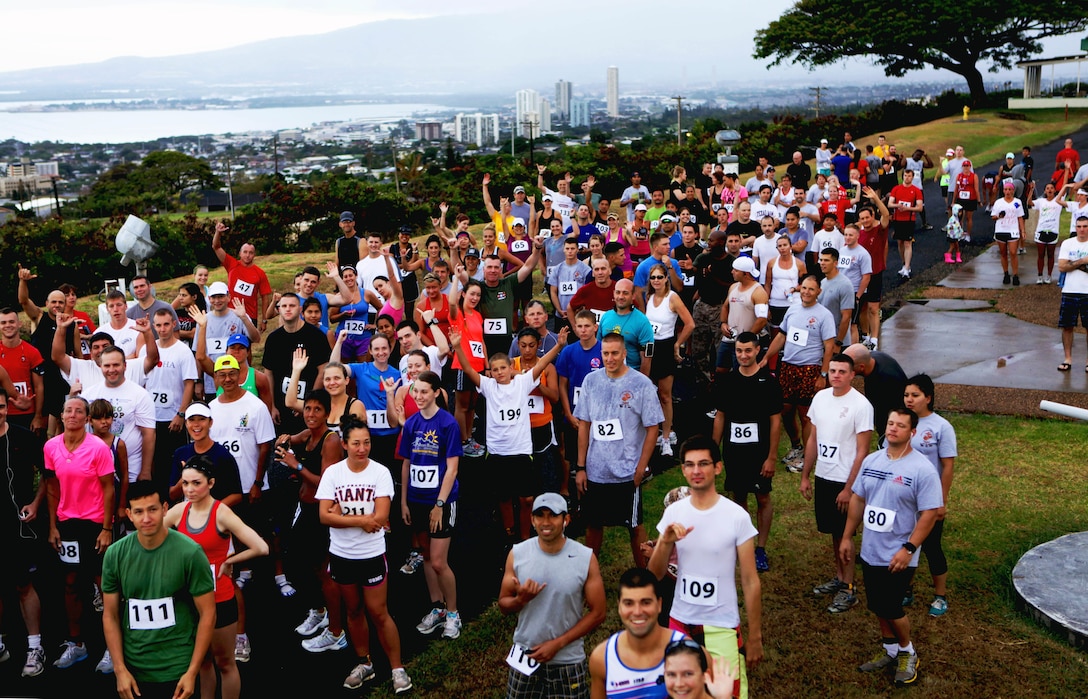 More than 210 military and civilian competitors shuffle into position before the start of the annual Camp Smith 5K Grueler here, July 28. The scenic starting point gave the runners a bird’s-eye view of Pearl Harbor, Honolulu and a vast portion of southern Oahu. The event gave Marines in different work sections a chance to bond, as well as build esprit de corps, said Capt. Greg Wagner, commander of Headquarters Company, Headquarters and Service Battalion, U.S. Marine Corps Forces, Pacific.  The large turnout allowed for some of the proceeds to offset ticket prices for junior service members during MarForPac’s Marine Corps birthday ball in November.