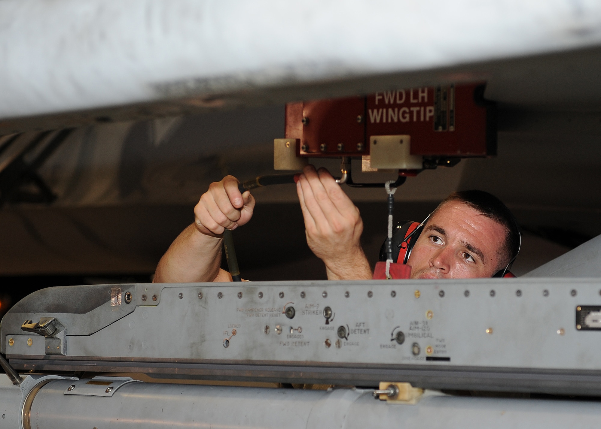 A member of Combat Shield makes an adjustment to testing equipment on Kunsan Air Base, Republic of Korea, July 26, 2012. They were testing the radar systems of the F-16 Fighting Falcon to make sure that it accurately picked up various types of signals and displayed them properly to the pilot. (U.S. Air Force photo/Staff Sgt. Jonathan Fowler)