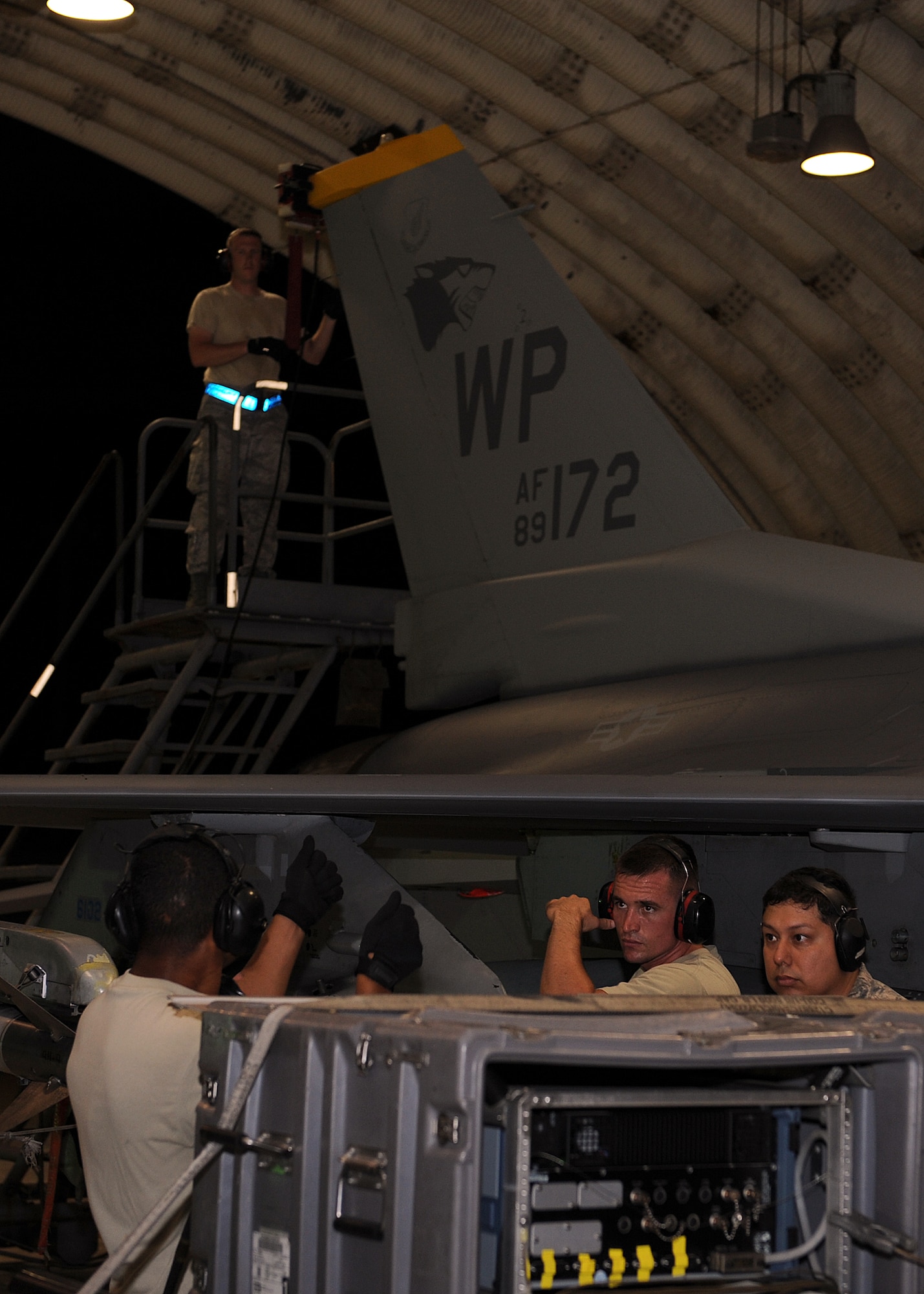 Members of Combat Shield make an adjustment to their testing equipment on Kunsan Air Base, Republic of Korea, July 26, 2012. They were testing the radar systems of the F-16 Fighting Falcon to make sure it accurately picked up various types of signals and displayed them properly to the pilot. (U.S. Air Force photo/Staff Sgt. Jonathan Fowler)