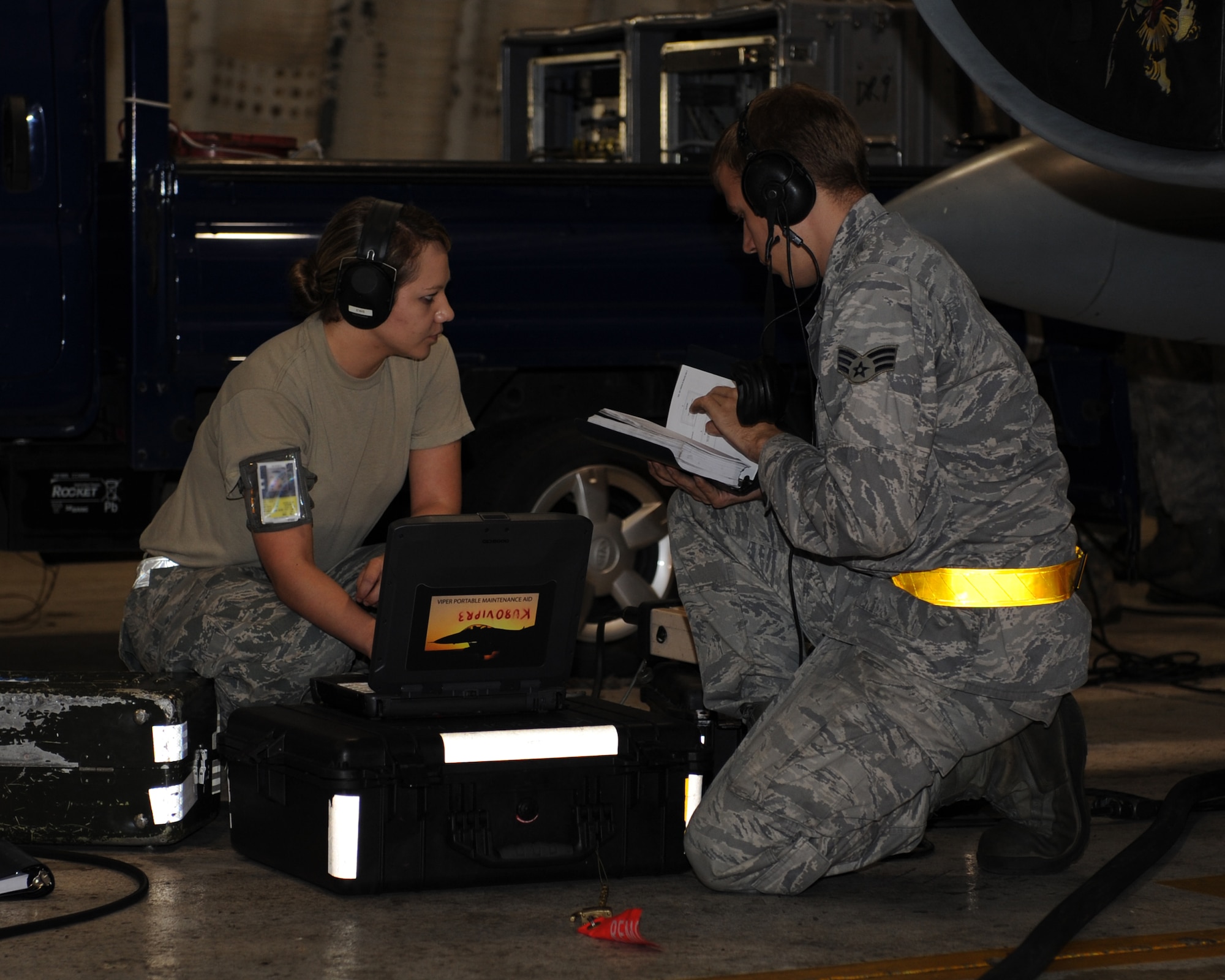 Members of the 8th Maintenance Squadron and the 8th Aircraft Maintenance Squadron review technical data while testing the radar threat warning systems of an F-16 Fighting Falcon on Kunsan Air Base, Republic of Korea, July 26, 2012. This is part of a test of numerous aircraft by Combat Shield, a group that goes around the Air Force testing the systems of various aircraft. (U.S. Air Force photo/Staff Sgt. Jonathan Fowler)