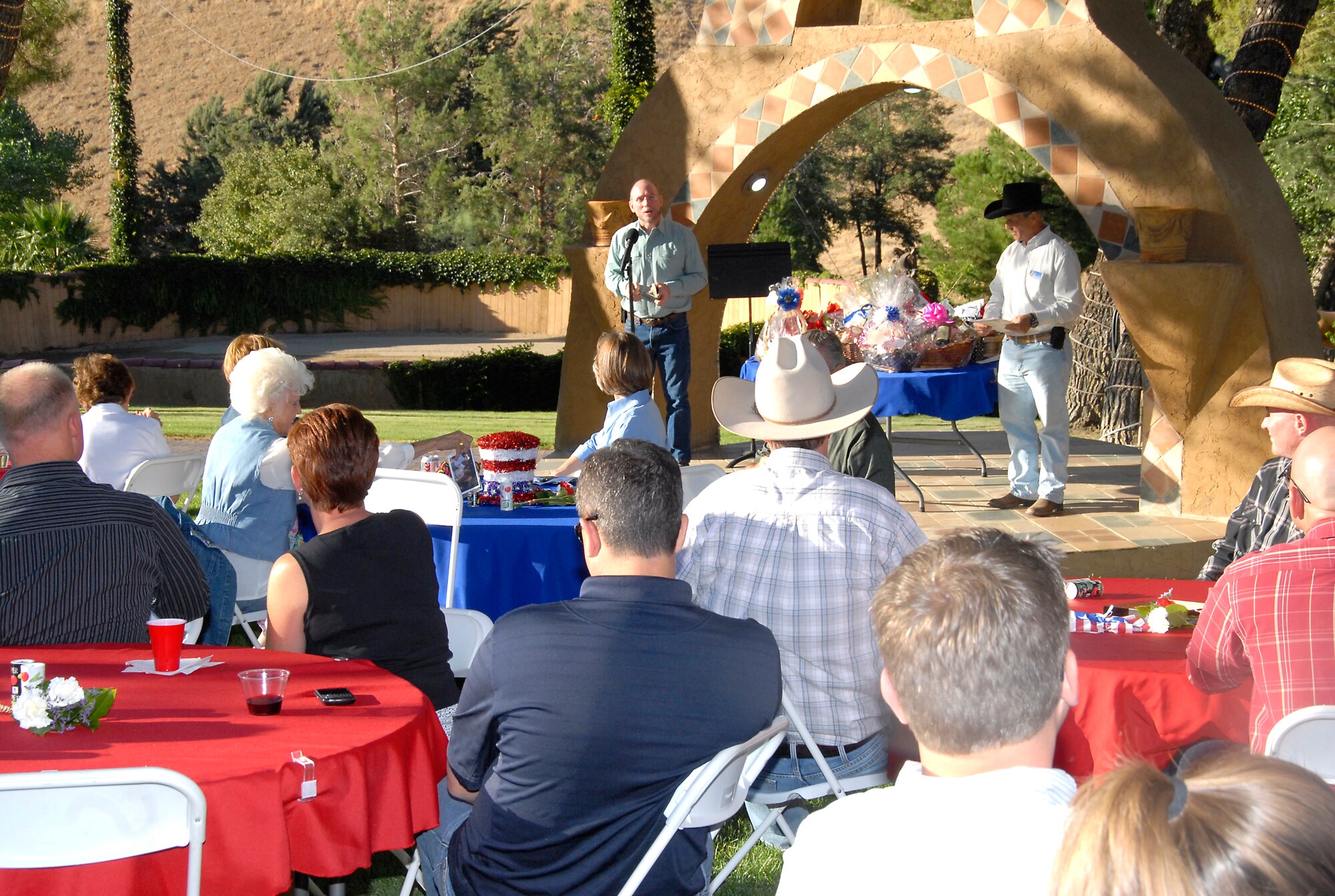 Davy M. Belk, Air Force Test Center technical director, addresses Team Edwards members and local leaders and supporters at the annual Edwards AFB Civilian-Military Support Group Barbeque.  Col. Amy Arwood, 412th Test Wing director of staff also spoke at the gathering, which raised funds for special projects on Edwards. (U.S. Air Force photo by Laura Mowry)