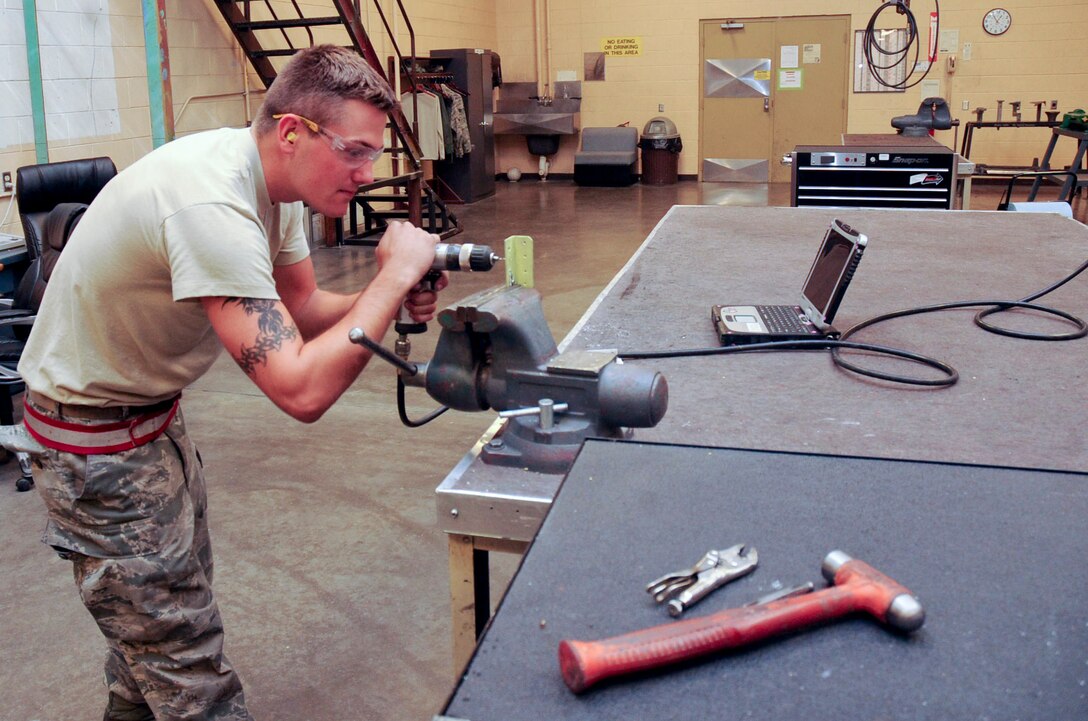 Senior Airman Richard McComb, 28th Maintenance Squadron aircraft structural maintenance journeyman, drills a hole through a nutplate hydroline bracket in the air structural maintenance building at Ellsworth Air Force Base, S.D., July 26, 2012. The bracket prevents the hydroline from rubbing against other aircraft parts during in flight turbulence. (U.S. Air Force photo by Airman 1st Class Anania Tekurio/Released)