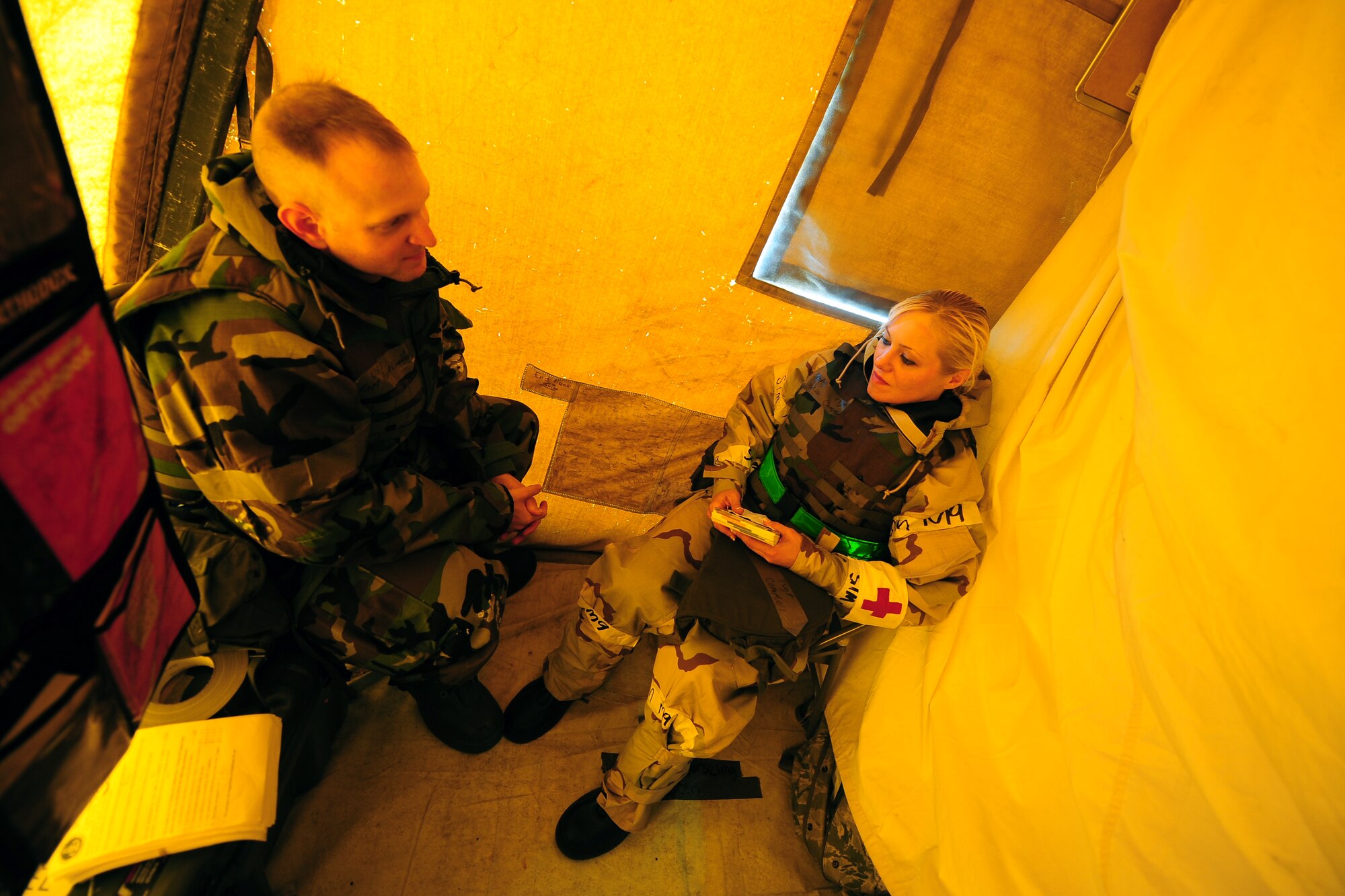U.S. Air Force Capt. Robert Chandler, 55th Wing chaplain, speaks with U.S. Air Force Tech. Sgt. Matilda Campbell, 55th Medical Support Squadron, inside of the Medical Control Center tent while going through an Operational Readiness Exercise held at Offutt Air Force Base, Neb., July 27.  Chaplains wear many hats both base-side and especially in deployed locations ensuring the spiritual well being of the war fighters around them. (U.S. Air Force Photo by Josh Plueger/Released)
