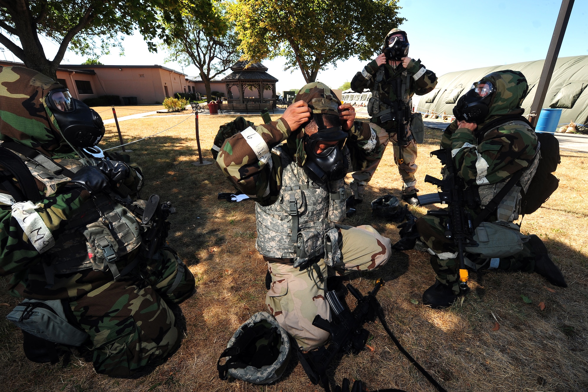 U.S. Air Force Senior Airman Fransico Marin, 55th Security Forces Squadron, gets the all clear to shed the MOP gear and resume normal patrol duties of “Base X” while training in and Operational Readiness Exercise at Offutt Air Force Base, Neb., July 27.  Base X is a variety of tents constructed behind the wing headquarters to represent a deployed station. (U.S. Air Force Photo by Josh Plueger/Released)