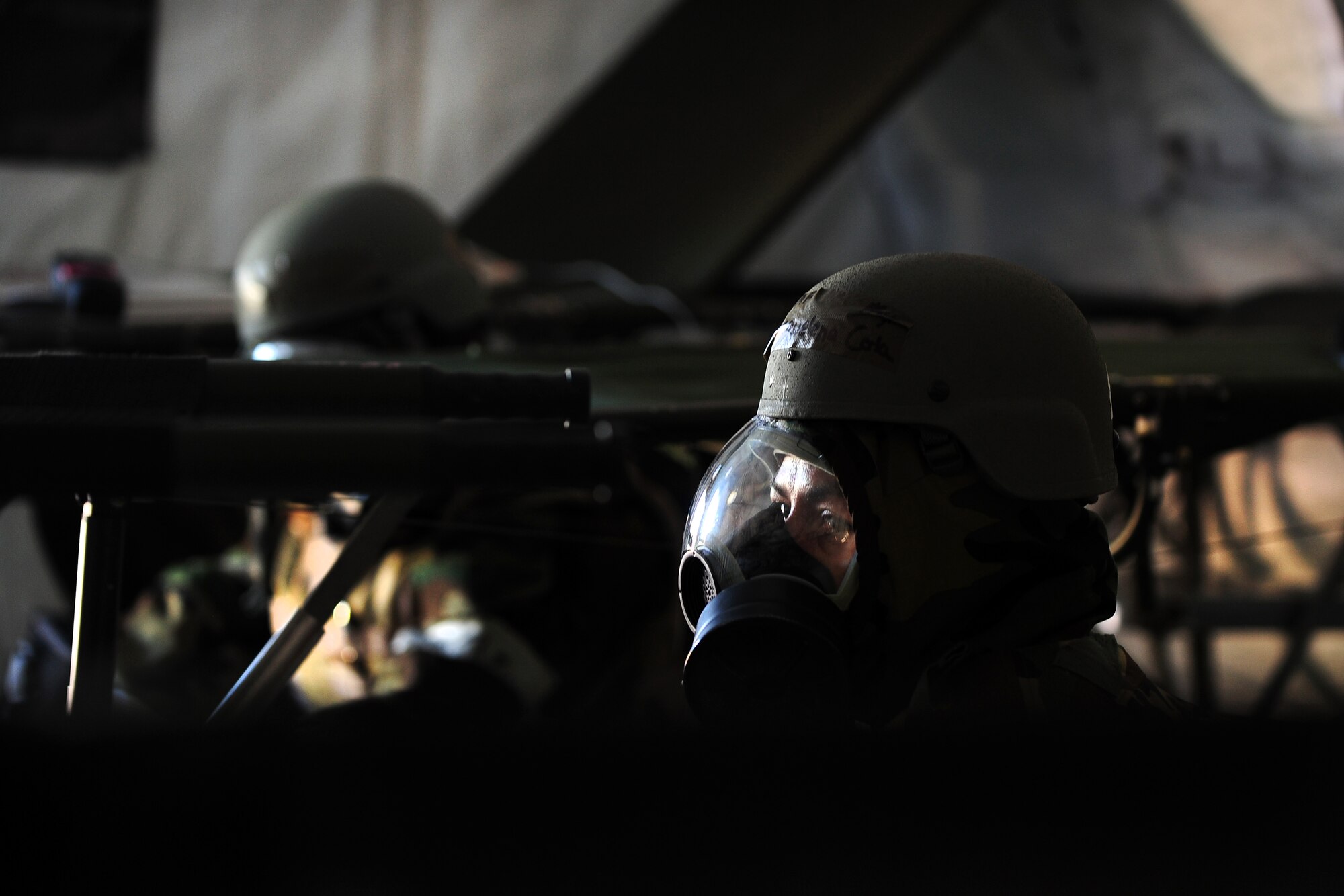 U.S. Air Force Master Sgt. Jacquelen Cota, 55th Aerospace Medicine Squadron, sits amongst vacant stretchers, in the “Base X” medical tent, waiting to hear from the loud speakers if she can remove the MOP 4 chemical gear and resume her duties as part of the Operational Readiness Exercise held at Offutt Air Force Base, Neb., July 27.  Exercises help keep the men and women of the Fightin’ Fifty-Fifth ready for all scenarios they could face while in deployed locations.  (U.S. Air Force Photo by Josh Plueger/Released)