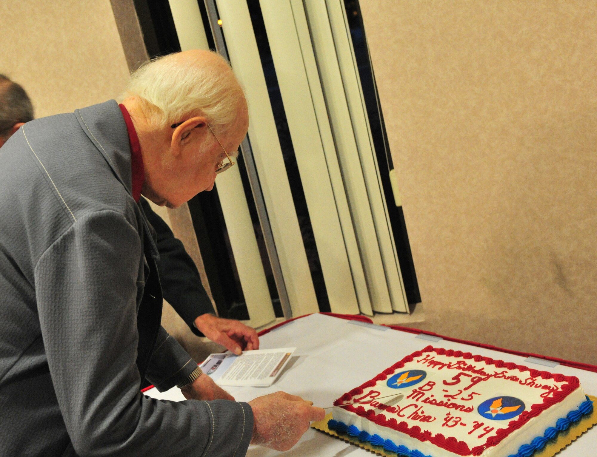 Ernie Shuey, retired military pilot, cuts his birthday cake during a meeting for the Order of Daedalians at Cannon Air Force Base, N.M., July 26, 2012. The Order of Daedalians was created in 1933 for pilots who flew during World War l and has since grown to include any rated pilot who served in the military. (U.S. Air Force photo/Airman 1st Class Xavier Lockley)
